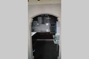 A kitchen or kitchenette at As Campanillas