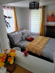 a bedroom with a bed and a table with flowers on it at Vibrant apartment in the heart of the town in Edmundston