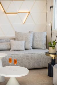 two wine glasses on a table in a living room at Amyth of Mykonos Super Paradise in Super Paradise Beach