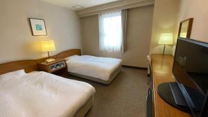Postel nebo postele na pokoji v ubytování Smile Hotel Nabari + 8 fotografií
