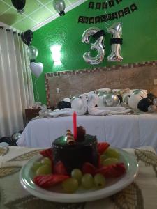 a table with a cake with a candle on a plate at Villa Victoria Pirámides in San Martín de las Pirámides +42 photos