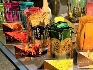 a glass table topped with different types of drinks and vases at Hotel Area One Oita in Oita