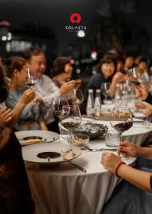 a group of people sitting at a table with wine glasses at Solaria Hanoi Hotel in Hanoi