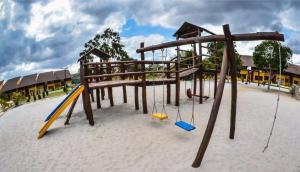 a playground with a swing set in the sand at Flat com Vista de Luxo! Winterville Gravatá in Gravatá