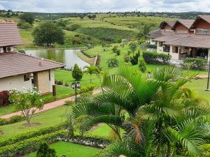 an aerial view of a village with a river and houses at Flat com Vista de Luxo! Winterville Gravatá in Gravatá