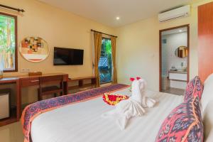 Tempat tidur dalam kamar di Gana Hotel & Restaurant