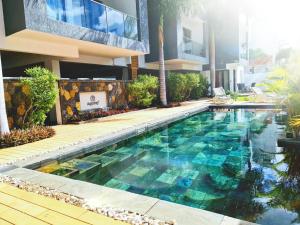 a swimming pool in front of a building at Beach luxury Penthouse in Flic-en-Flac