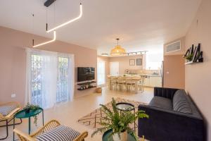 a living room with a couch and a table at Eilat vacation house דירות נופש אילת in Eilat