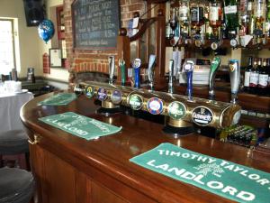 a bar in a pub with a counter with beers at Jolly Brewers Free House Inn in Bishops Stortford