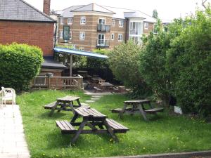 a group of picnic tables sitting in the grass at Jolly Brewers Free House Inn in Bishops Stortford