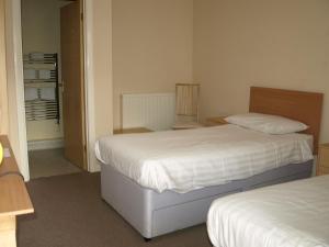 a bedroom with two beds and a closet at Jolly Brewers Free House Inn in Bishops Stortford