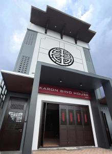 a korean blind house with a clock on top of it at KARON SINO House in Karon Beach