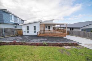 a house with a large deck in a yard at Port View Escape in Bridport