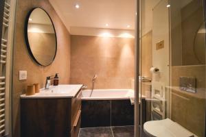 a bathroom with a sink and a mirror at Hôtel Azur in Reims +35 photos