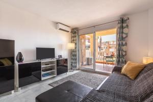 a living room with a couch and a television at Apartment 925 in Marbella