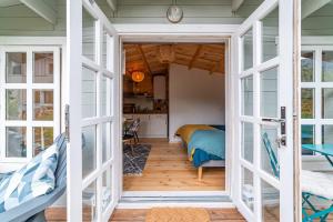 a room with a door open to a bedroom at Hygge Lodge Annecy in Doussard