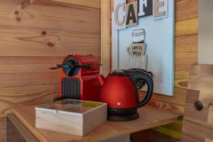 a red blender sitting on a wooden table at Hygge Lodge Annecy in Doussard