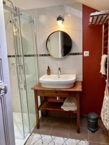 a bathroom with a sink and a shower at Chambre Loulou • Maison Colombage in Provins