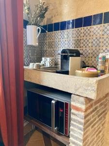 a kitchen with a counter with a coffee maker at Chambre Loulou • Maison Colombage in Provins