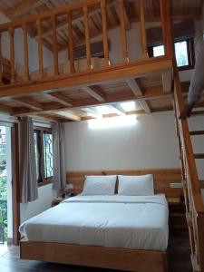 a bedroom with a loft bed with a ladder at The Kumaon Retreat in Nainital