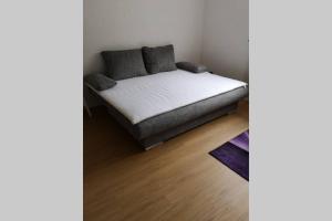 a bed in a corner of a room at Ferienwohnung Susanne, Losheim am See in Wahlen