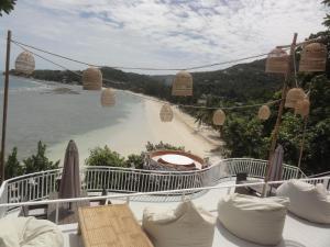 a view of a beach with a boat in the water at High Life Bungalow in Haad Yao