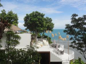 a view from a balcony overlooking a beach with palm trees at High Life Bungalow in Haad Yao