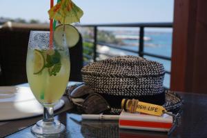 a drink on a table with a view of the ocean at High Life in Kérynia