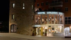 a building with a clock on the front of it at Hotel Goldene Rose in Brunico