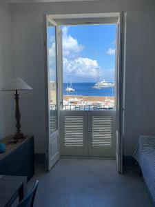 an open door to a room with a view of the ocean at Appartamenti Marina Corta in Lipari