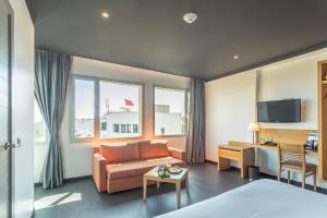 a hotel room with a couch and a desk at ONOMO Hotel Rabat Medina in Rabat