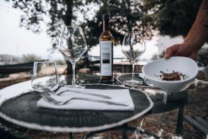 a table with a bottle of wine and two wine glasses at La casa del tartufo in Torri in Sabina