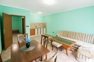 a living room with a couch and a table at Апартамент Морски бриз in Balchik
