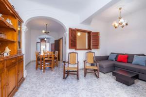 a living room with a couch and a table at House by the sea in Can Picafort with terrace in Can Picafort