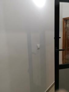 a white wall with a door in a room at Sweet Home in Dakar