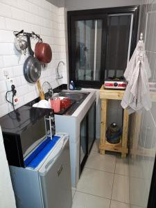 a kitchen with a sink and a microwave at Sweet Home in Dakar