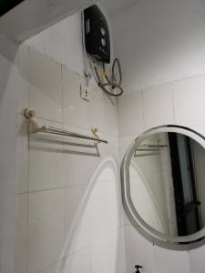 a bathroom with a mirror and a towel rack at Sweet Home in Dakar