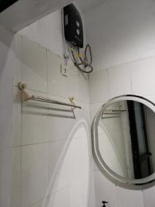a bathroom with a mirror and a towel rack at Sweet Home in Dakar +10 photos