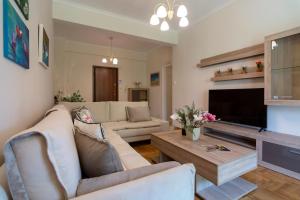 a living room with a couch and a table at Acropolis View 2BD Apt next to Museum & Metro in Athens