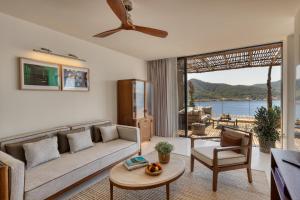 a living room with a couch and a table at Six Senses Ibiza in Portinatx