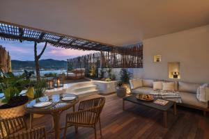a living room with a couch and a table at Six Senses Ibiza in Portinatx