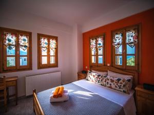 A bed or beds in a room at Orange House for big families in Damouchari - Delicious Houses
