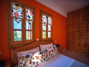 A bed or beds in a room at Orange House for big families in Damouchari - Delicious Houses