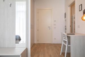 a kitchen with a counter and a table with a chair at Casa LiLu by Comorooms in Como