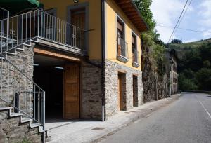 a building with a garage with a door at Casa Rural Las Mestas in Cangas del Narcea