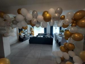 a bunch of balloons hanging in a living room at Willa Magnolia in Szczecin