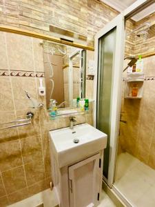 a bathroom with a sink and a shower at Cosy Flat Beachfront in Flic-en-Flac +9 photos