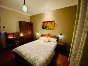 a bedroom with a white bed in a room at Cosy Flat Beachfront in Flic-en-Flac