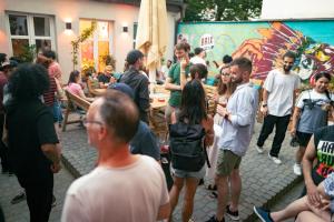 a group of people standing around in a crowd at Brix Hostel in Prague