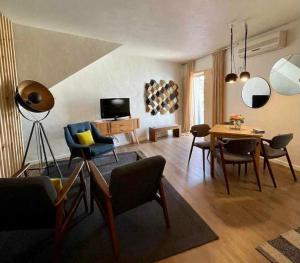 a living room with a table and chairs at Casas Do Moinho - Turismo De Aldeia in Odeceixe